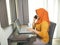 Asian muslim woman wearing hijab smiling while talking on phone, Successful businesswoman entrepreneur working at home. Wireless