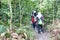 Asian muslimah female hiking in tropical rainforest in the morning
