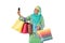 Asian muslimah woman with bright wicker tote bags taking selfie.