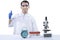 Asian nerd scientist standing and showing thumb up with a microscope and medical tube rack on the desk