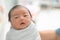 Asian newborn baby in  bassinet at delivery room at hospital