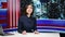 Asian news anchor hosting live broadcast