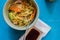 Asian noodles with chicken, vegetables in bowl, Closeup. Asian style dinner