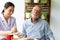 Asian nurse assist happy senior retirement man having breakfast together