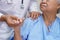 Asian nurse physiotherapist doctor touching Asian senior or elderly old lady woman patient with love