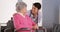 Asian nurse talking with Senior patient