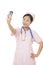 Asian nurse using a cell photo to take a Selfie isolated on white background