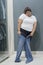 Asian obese woman trying to wear tight jeans