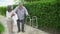 Asian old couple walk with walker at  home. senior man using a walker  working with elder woman in the park . mature husband and