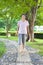 Asian older woman walking on the stone walkway