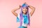 Asian otaku girl in purple wig standing on pink