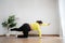 Asian overweight woman doing stretching exercise at home on fitness mat. Home activity training, online fitness class. Stretching