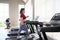 Asian overweight women in sportswear running on treadmill in fitness club. Weight loss workout, healthy lifestyle concept