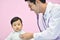 Asian paediatrician examining a baby with a stethoscope