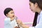 Asian paediatrician examining a baby with a stethoscope