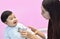 Asian paediatrician examining a baby with a stethoscope