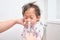 Asian Parent flushing her sick happy smiling cute little toddler baby girl child nose with syringe for nasal Irrigation, Saltwater