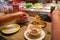 Asian people eating enoki mushroom hotpot at conveyor belt restaurant