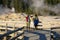 Asian people visit geysers at Yellowstone