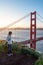 Asian photographer at Golden Gate Bridge