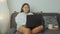 Asian plus size woman working online with laptop at home
