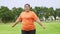 Asian Plus size woman workout in park and stretch muscles before jogging. Happy cheerful young obese girl smiling outdoors in