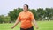 Asian Plus size woman workout in park and stretch muscles before jogging. Happy cheerful young obese girl smiling outdoors in