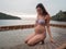 Asian pregnant woman in bikini sitting on hammock in turquoise sea water near beach. tropical beach in Koh Kut Island, Thailand. p