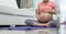 Asian Pregnant Woman in sitting touching her belly while doing yoga exercise