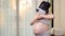 Asian Pregnant woman wearing virtual reality headset for Parenting trial. VR technology of pregnancy