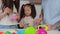 Asian preschool age girl playing kids kitchen set toy