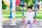 Asian preschool little child boy sitting on red swings  lonely or sad gestures unhappy. A scared little child is 2 years old.