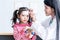 Asian pretty woman doctor Is pasting a fever reducing gel Forehead area