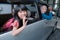 asian primary pupil student sitting in the car and waving good bye