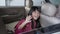 asian primary pupil student sitting in the car and waving good bye