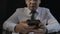 Asian professional businessman holding modern smartphone texting message in office. Man using mobile apps while sitting at work