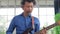 Asian professional musician playing electric guitar in music practice room.