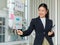 Asian professional successful female businesswoman lecturer presenter in formal business suit standing using marker pointing