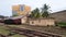 Asian railway station, palm trees, white and blue building