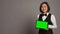 Asian receptionist holding tablet with greenscreen on camera,