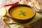 Asian red lentil and vegetable puree soup served with bread and lemon close-up in a bowl. horizontal