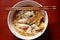 Asian rice noodle soup with pork, fish ball and crisps dumpling.