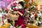 Asian saleswoman in mask selling Christmas decorations