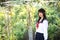 Asian school girl walk and looking with flower garden background