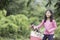 Asian schoolgirl with long hair enjoying a bike ride with her puppy