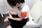 Asian schoolgirl using cell phone chat send messages sit on toilet bowl during study hours,lazy lady girl skipping class to play