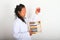 Asian scientist in lab coat counting on abacus with blood samples in hand