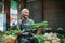 asian seller holding greens vegetable stall