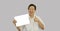 Asian seniior elder woman holding white board space for happy advertising suggestion with hand gestures