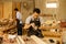 Asian senior carpenters work with young carpenters in an industrious furniture factory.